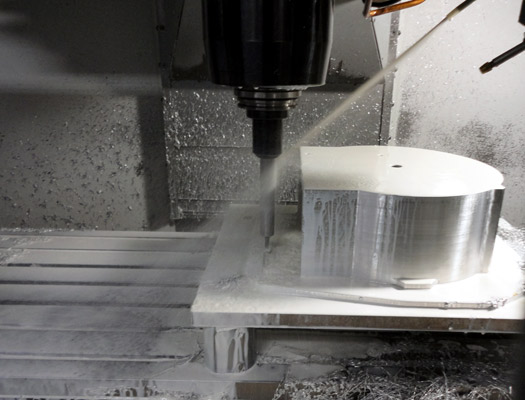 CNC machine cutting a precision aluminum component at G&amp;Z Industries